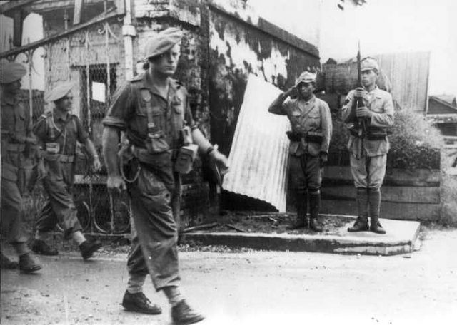 Free French 6th Commando C.L.I. in Saigon are saluted by surrendered Japanese in November 1945.