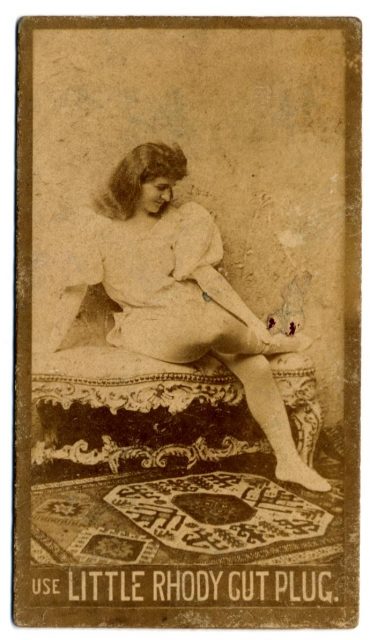 Full portrait of unnamed actress sitting on a sofa with her legs crossed, on Little Rhody Cut Plug tobacco card. Photo by Dr. Charles H. McCaghy Collection