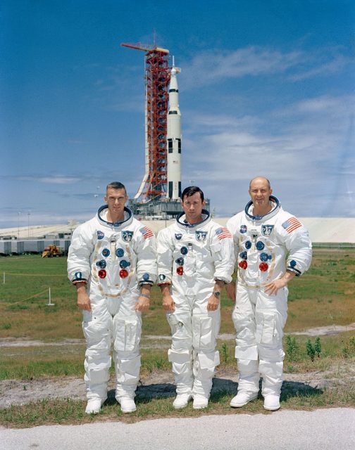 The crew poses with their launch vehicle. Left to right: Cernan, Young, Stafford.