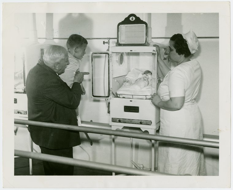 Martin and Hildegarde Couney with boy looking at baby in incubator. Photo by NYPL