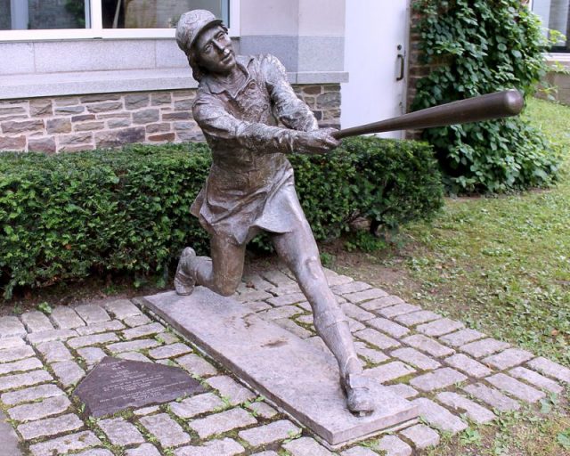 Bronze sculpture at the Baseball Hall of Fame which commemorates the All-American Girls Professional Baseball League. Photo by Eric Enferemero CC BY SA 4.0