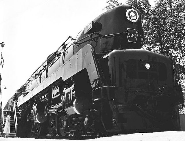 Black and big, the Pennsylvania Railroad TR1 locomotive. Notice how tiny the woman looks on the left.