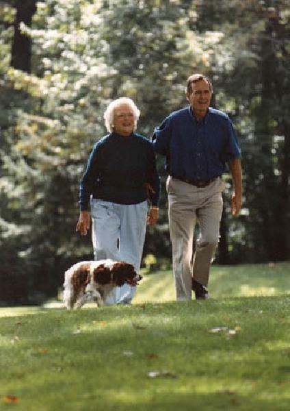 President and Mrs Bush walk with Millie at Camp David September 19, 1992.