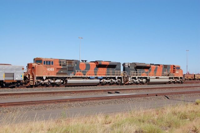 Diesel locomotives in BHP Billiton Iron Ore “bubble” livery, at the company’s Nelson Point Yard, Port Hedland, Western Australia. Photo by: Bahnfrend – CC BY-SA 3.0