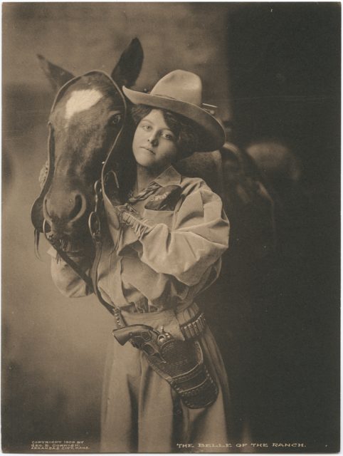 A woman photographed with her horse in 1909. Notice the revolver?!
