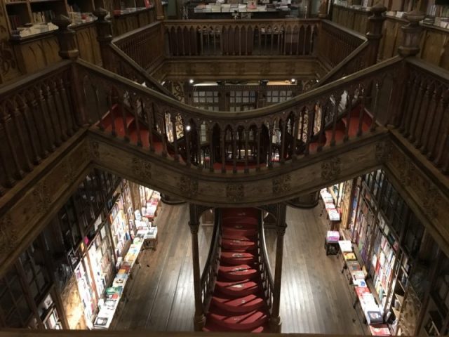 Look up at the highest glass-fronted shelves on the first floor of Livraria Lello. These are packed full of old and intriguing looking books.