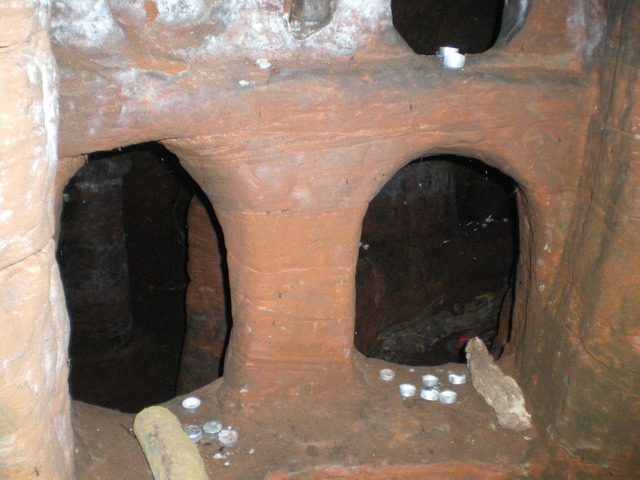 Underground in the Caynton Hall grotto. Part of the interior of the grotto. A number of ‘nightlight’ candles have been left lying around, presumably by local youths who camp out there sometimes. Photo by Richard Law CC BY SA 2.0