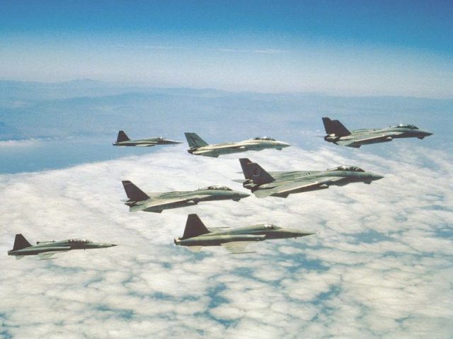 A formation of F-14A Tomcats of Fighter Squadrons VF-51 Screaming Eagles and VF-111 Sundowners, and F-5E/F Tiger II’s of the Navy Fighter Weapons School. These units represented a vital part of the U.S. Navy’s participation in “Top Gun,” providing the aerial dogfighting sequences that were a defining trademark of this movie. Note the fictitious markings on the tail of at least one of the F-14’s.