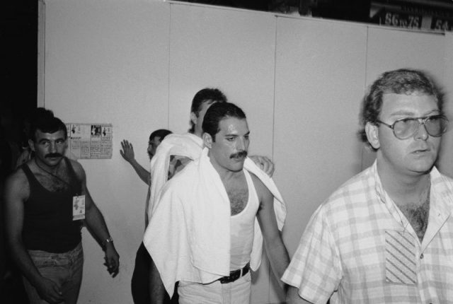 Freddie Mercury backstage at the Live Aid concert at Wembley, July 13, 1985. On the left is his boyfriend Jim Hutton. Photo by Dave Hogan/Hulton Archive/Getty Images