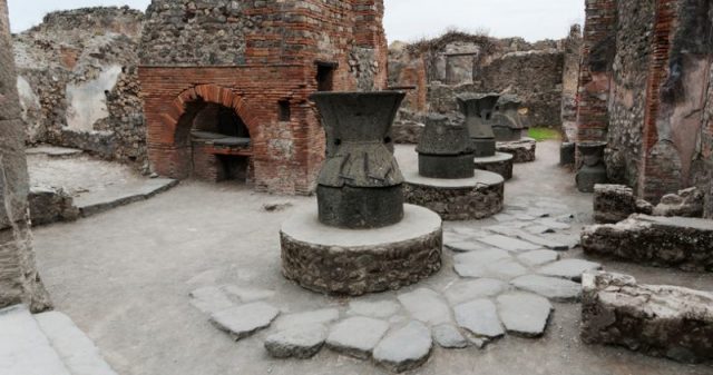Oven and stone hand mills (mola asinaria) for grinding grain, Pompeii, Campania, Italy.