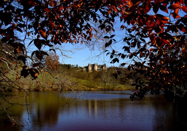 Asheville, NC, United States – October 31, 2010: The historic Biltmore Estate, largest privately owned home in the United States, seen on a hill from a nearby lake.