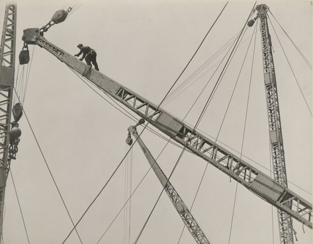Jumping the derrick, by Lewis Hine.