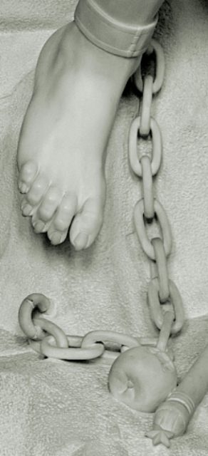 Detail of Le Génie du Mal: chained ankle, tasted apple, broken sceptre. Photo by Luc Viatour CC BY-SA 3.0