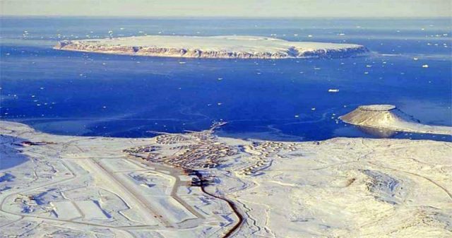 Thule Air Base in the foreground with North Star Bay, which was covered in sea ice at the time of the accident, in the background.