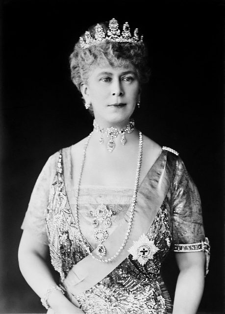 Mary in tiara and gown wearing a choker necklace and a string of pearls.