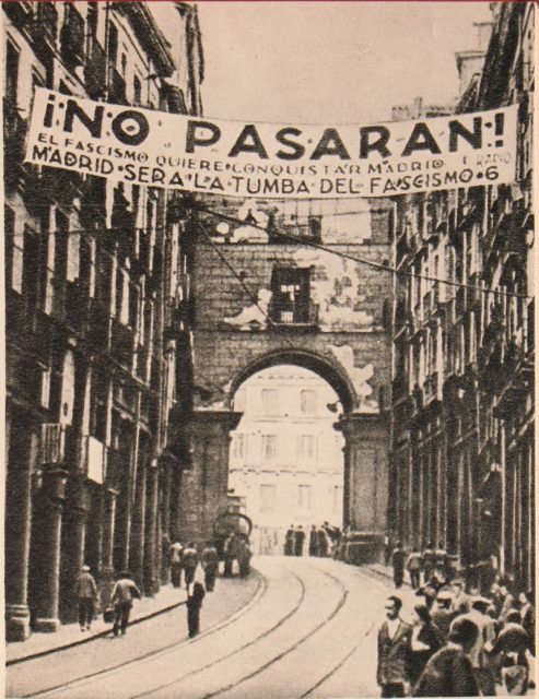 A banner reading ¡No pasarán! Madrid will be the graveyard of fascism from the Siege of Madrid. Photo taken by Soviet journalist Mikhail Koltsov.