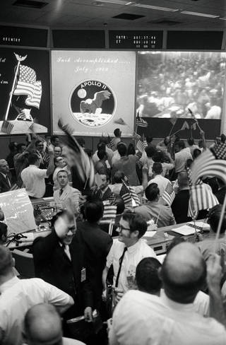 Flight controllers celebrate the successful conclusion of the Apollo 11 lunar landing mission on July 24, 1969, at NASA’s Mission Control Center in Houston. Photo by NASA