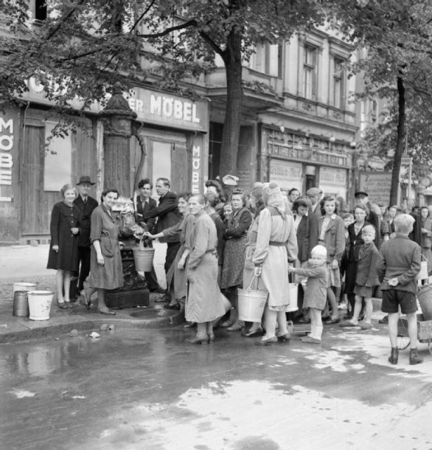 Germany under Allied occupation. German civilians queue at a streetside water pump in Berlin. Such pumps provided the only source of clean water in the German capital due to the destruction of much of the mains system.