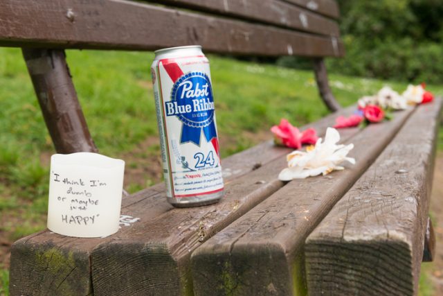 Pabst Blue Ribbon beer and flowers left on Kurts Bench by fans 22 years after Kurt Cobain committed suicide in the home just next door to Viretta park. The bench in the Madrona neighborhood has become a place visited by tourists from around the world, they leave items Kurt would have liked and scribble personal messages to the music icon. Kurt was known to sit on the bench and play his guitar.