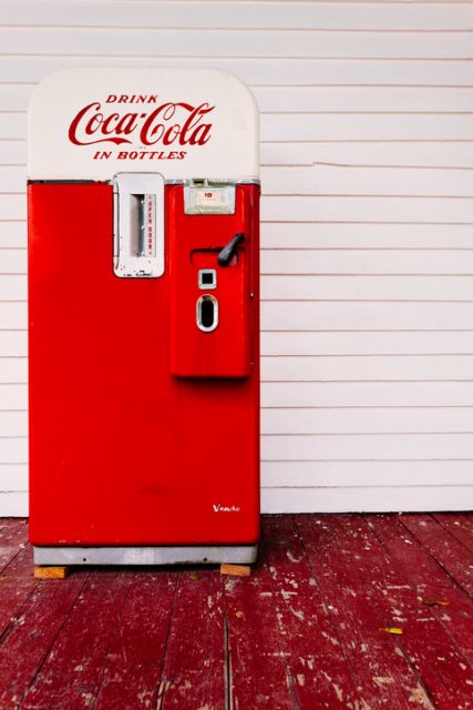 A red vintage coca cola vending machine.