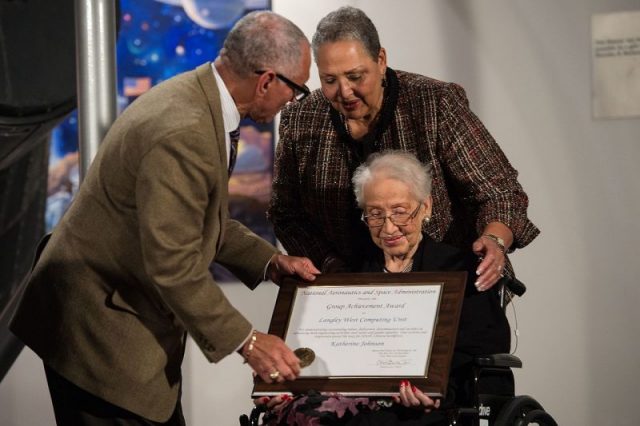 NASA Administrator Charles Bolden presents an award to Katherine Johnson, the African American mathematician, physicist, and space scientist, who calculated flight trajectories for John Glenn’s first orbital flight in 1962, at a reception to honor members of the segregated West Area Computers division of Langley Research Center.