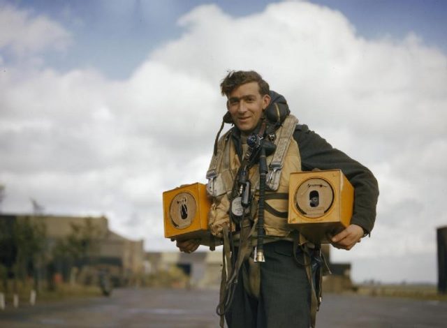 Canadian PO (A) S Jess, wireless operator of an Avro Lancaster bomber operating from Waddington, Lincolnshire carrying two pigeon boxes.