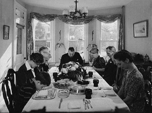 Saying grace before carving the turkey at Thanksgiving dinner in the home of Earle Landis in Neffsville, Pennsylvania, 1942