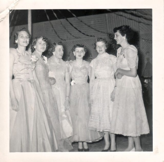 Prom in the 1950s. Timeless simple lines for these formally dressed young ladies.