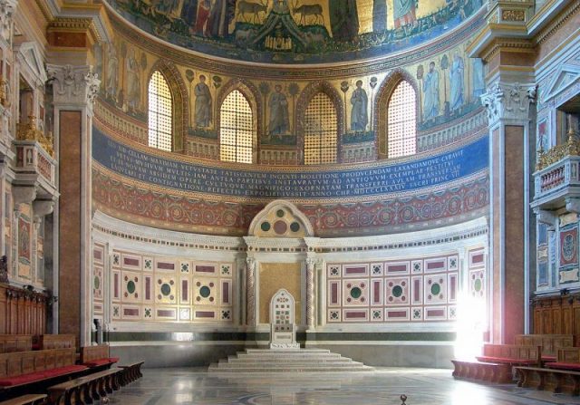 The papal throne (cathedra), in the apse of Archbasilica of St. John Lateran, symbolises the Holy See. Photo by Ern – Flickr CC BY-SA 2.0