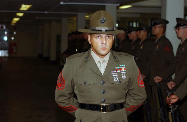 A U.S. Marine Senior Drill Instructor supervises the inspection of his platoon