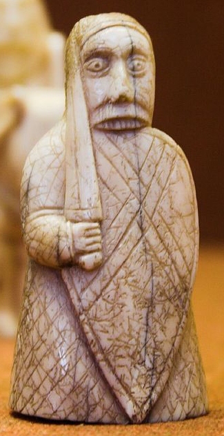A rook piece from the Lewis chessmen, depicted as a warrior biting his shield. Photo by Rob Roy CC BY 2.0