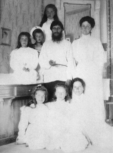 Empress Alexandra Feodorovna with Rasputin, her children and a governess.