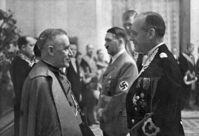 Cesare Orsenigo (left, with Hitler and von Ribbentrop), nuncio to Germany, also served as de facto nuncio to Poland. Photo by Bundesarchiv, Bild 183-H26878 / CC-BY-SA 3.0