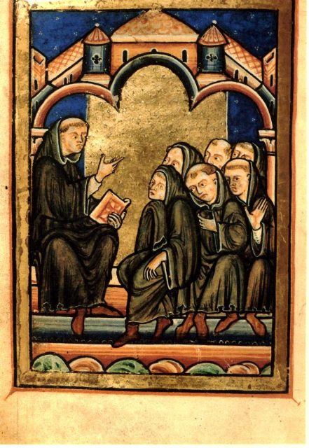 Cuthbert teaching with a book in his hand (Ch 16, Life of Cuthbert).