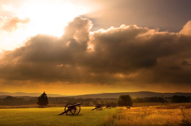Sunrise silhouette of monument and cannon at Antietam Battlefield at Sharpsburg, Maryland, USA.
