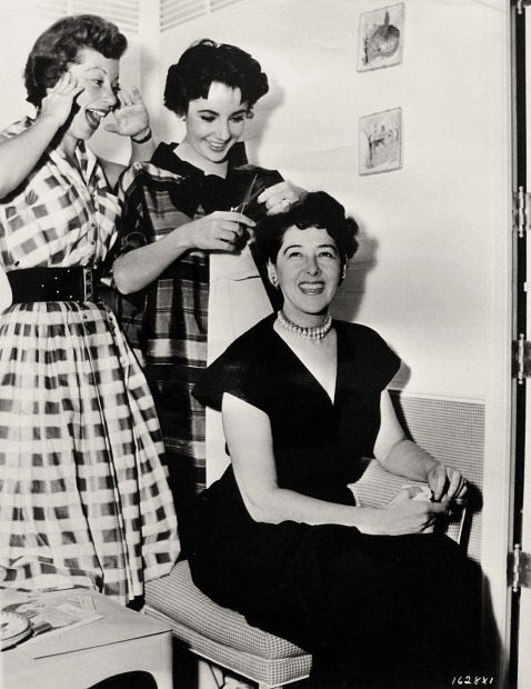 L. to R. : Annabella Levy (hairdresser), Elizabeth Taylor, and Helen Rose (costume designer) on the set of Rhapsody (1954) – publicity still.