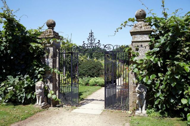 Lion Gate’ to the Walled Garden of Parham House, West Sussex, England. photo by Acabashi CC BY SA 4.0