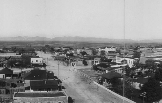 Third St. in Tombstone, Arizona in 1909 from the roof of the Cochise County Courthouse. The O.K. Corral was located on Allen St., the first right turn off Third St. The white building at the center right is Schiefflin Hall on Fremont St.