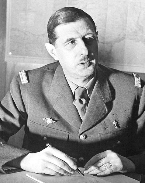 Commander of the Free French Forces Charles de Gaulle, seated.