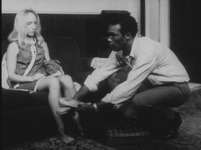 Actor Duane Jones as Ben gives actress Judith O’Dea, playing Barbra, her slippers in a scene from the movie Night of the Living Dead
