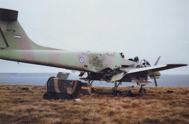 Damaged IA 58 “Pucará” at Pebble Island, 1982 Photo by Ken Griffiths CC BY-SA 3.0