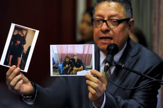 Carlos Guzman, representative of the Masonek Law Offices, attorney of Salvadorean castaway Jose Salvador Alvarenga, shows pictures of his client in the Marshalls islands, during a press conference in San Salvador. AFP PHOTO/ Jose CABEZAS. Photo by JOSE CABEZAS/AFP/Getty Images