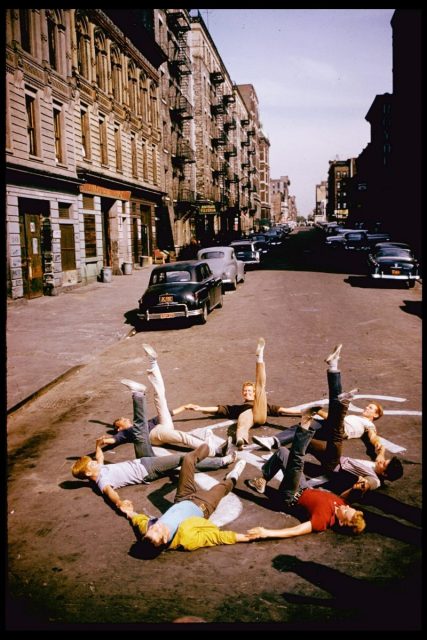 Russ Tamblyn, wearing yellow jacket as Riff, leader of the Jets, with other gang members in exuberant dance on busy street in scene from ‘West Side Story.’ (Photo by Gjon Mili/The LIFE Picture Collection/Getty Images)