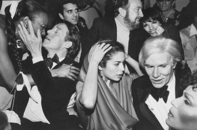 Celebrities during New Year’s Eve party at Studio 54: (l-r) Halston, Bianca Jagger, Jack Haley, Jr. (bkgrd), Liza Minnelli (bkgrd), Andy Warhol. (Photo by Robin Platzer/Twin Images/The LIFE Images Collection/Getty Images)