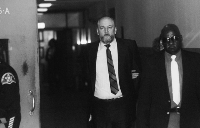 Richard Kuklinski, known as the Iceman, is led into Bergen County Court. Kuklinski, indicted for six murders, appeared in court after having kidney stones during the previous weekend.