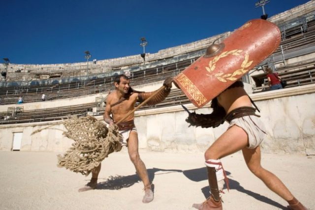 Re-enactment of a gladiator fight in the arena of Nîmes. Photo by Culturespaces/Christophe Recoura CC BY-SA 3.0