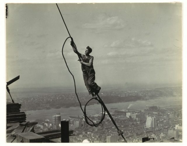A photograph of a cable worker, taken by Lewis Hine as part of his project.