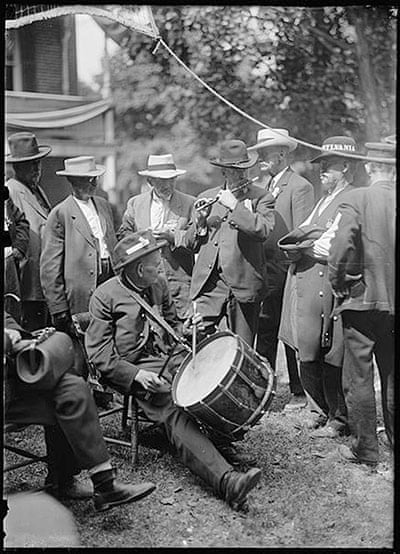 Confederate and Union veterans pass the time with a drum-and-fife corps.