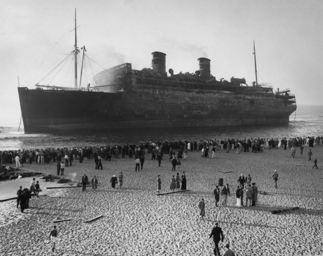 9/9/34 – Asbury Park, New Jersey: Scene from the beach at Asbury Park showing the S.S. Morro Castle, still smoking, as she appeared after being beached.