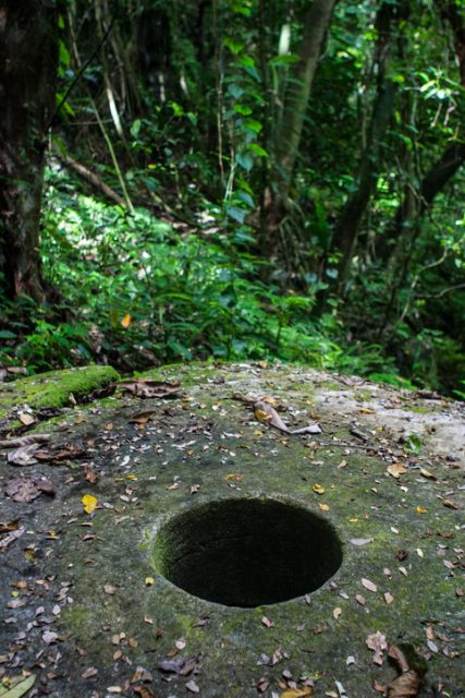 A massive piece of Yapese stone money lies near the quarry it was carved from in Palau, Micronesia. This money is the largest type of currency in the world.